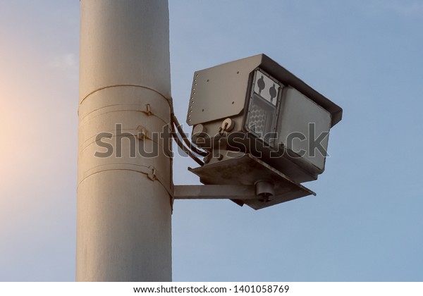 Traffic police speed radar on a pole in the city on\
the road. Bottom view