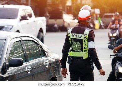 Traffic policeman in uniform : Acting, and dressing Thai traffic police on the road.
