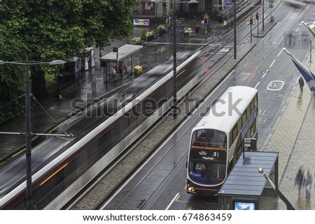 traffic in Princes Street, edinburgh, in a rainy afternoon
