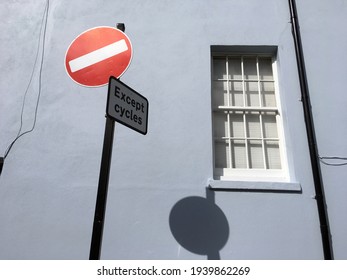 Traffic Road Signs Against House Wall. No Entry Sign With Exception For Cycles On Post