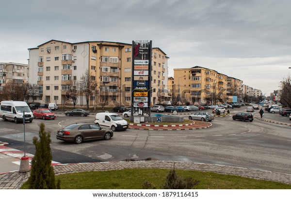 Traffic in\
the roundabout of the city. Traffic circle with cars. Road circle.\
Targu Jiu, Romania, October 29,\
2020