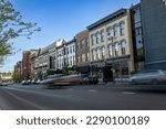 Traffic is running in front of shopping complex storefronts on the square around Main Street in downtown district of Lexington, Kentucky 