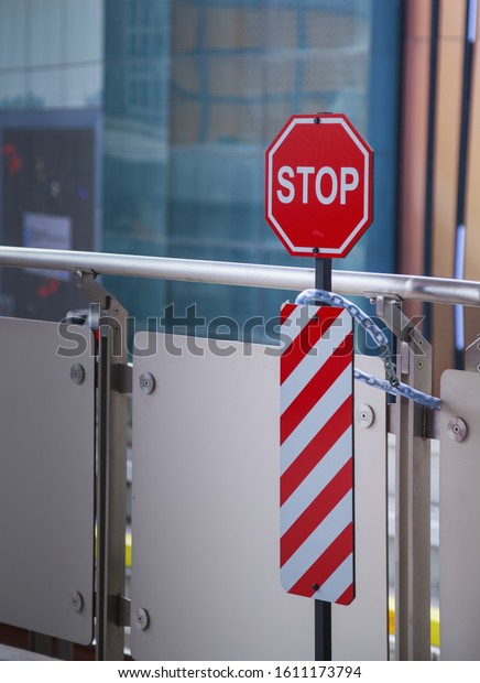 Traffic safety warning signage, A stop restrictive\
octagon sign with red, white vertical diagonal stripes (striped\
delineators) designed to notify obstacle barrier ahead, passerby\
must completely stop