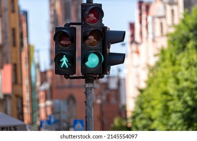 Traffic Semaphore With Green Light And Green Figure Of Pedestrian On Defocused City Street, Closeup