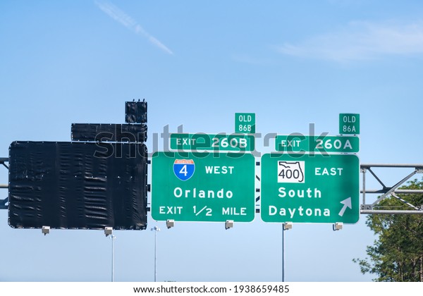 Traffic sign for exits 260A, 260B to 400 East road\
to South Daytona beach, Florida with direction to Orlando city on\
interstate highway 4 in\
summer