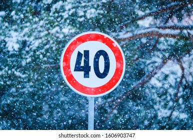 traffic sign and fresh snow sped limit