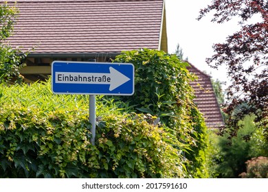 Traffic sign with German text "Einbahnstraße" translated into "One-way street" in English language