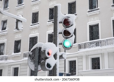 Traffic Sign Of A Green Traffic Light Covered With Snow On A Snowy Winter Day