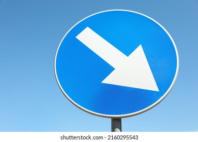 Traffic sign Keep Right against blue sky, low angle view