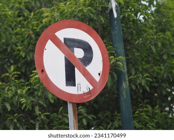 A traffic sign, No Parking sign.