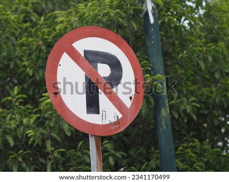 A traffic sign, No Parking sign.