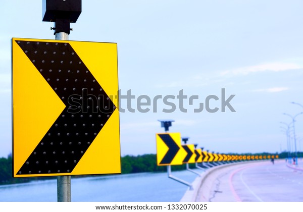 Traffic\
sign on the curve with blur background in pastel color, LED traffic\
signs can save electricity and save energy that will be used to\
generate electricity to reduce global\
warming.