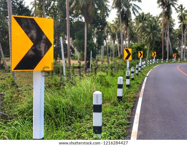 Traffic sign on the road or\
Traffic Sign and other traffic sign beside road with landscape in\
Thailand.
