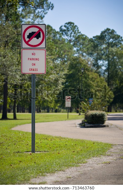Traffic sign\
prohibiting the parking on the grass in the park. Nature. Road sign\
in the rest area. Rules for\
travelers.