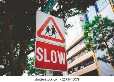 Traffic Sign Slow And Warning School Zone Traffic Sign In Downtown Singapore