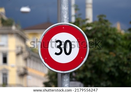 Traffic sign speed limit 30 kilometers per hour at City of Lugano on a cloudy summer day. Photo taken July 4th, 2022, Lugano, Switzerland.