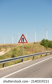 Traffic Sign Warning Of Narrow Road Ahead, In Area Near Wind Farm