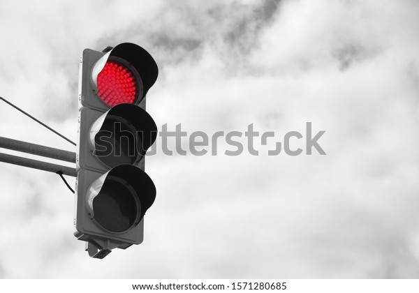 Traffic signal\
with sky and clouds\
background.