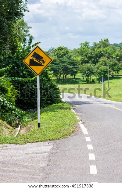 traffic signals, signs down\
a slope.