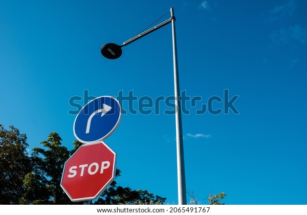 Traffic signals and street light. Stop and\
obligation signals. Blue\
sky.