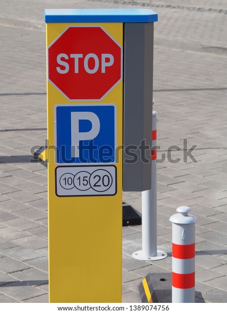Traffic signs and automatic paid parking\
in the city. Parking problems in the city\
center.