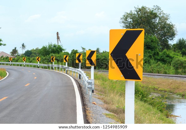 Traffic signs Be careful of roads and curves.\
Drive slowly and be careful of the curves ahead on rural highways\
and beautiful blue\
skies.