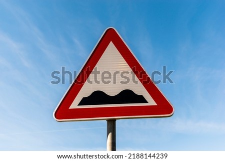 A Traffic signs, bumpy road.