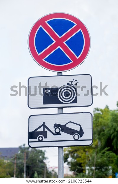 Traffic signs: car evacuation, no\
parking, surveillance camera. International traffic signs on a\
street. Transport and traffic\
infrastructure.