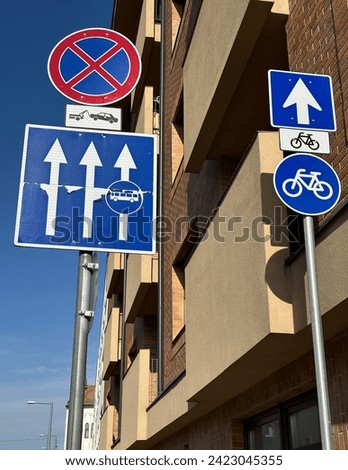 Traffic signs next to a building on the street