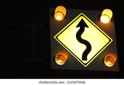 Traffic Signs With Right Or Left Hand Bends That Are Lit At Night                               