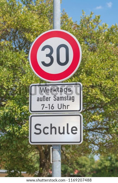 Traffic signs\
for speed limit on 30 km/h, on workdays in the area of a school in\
the time of from 7 to 16\
o\'clock