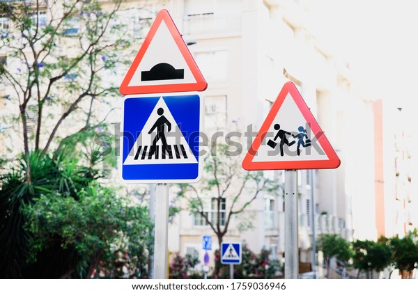 Traffic signs warning of children and pedestrian\
walks in an urban area.