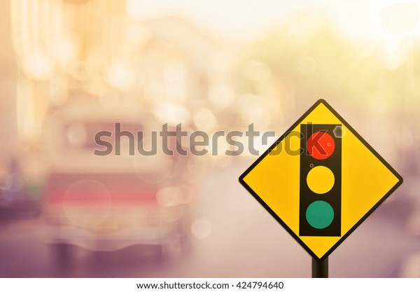 Traffic sign,traffic light\
sign on blur traffic road abstract background.Retro color\
style.