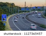 Traffic speeds along the M5 motorway near the intersection with the M4 in Bristol, England, during sunset