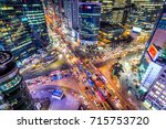 Traffic speeds through an intersection at night in Gangnam, Seoul in South Korea.