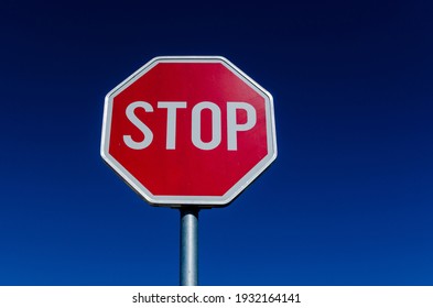 A Traffic STOP Sign And Blue Sky