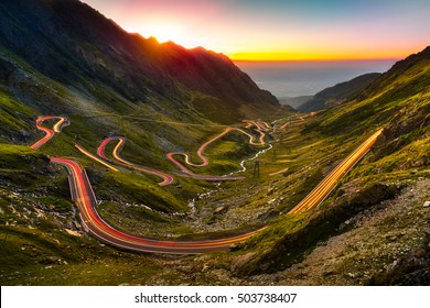 Traffic trails on Transfagarasan pass at sunset. Crossing Carpathian mountains in Romania, Transfagarasan is one of the most spectacular mountain roads in the world.