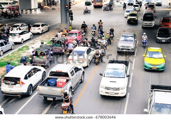 Traffic is unstable\
or Busy traffic with car, van, taxi cab near middle cityscape in\
Bangkok on July 15,\
2017