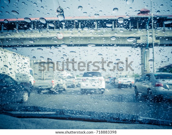 Traffic\
view from car windscreen in rain.Driving in\
rain