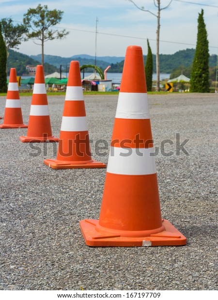traffic warning cone in row to separate route in
parking area