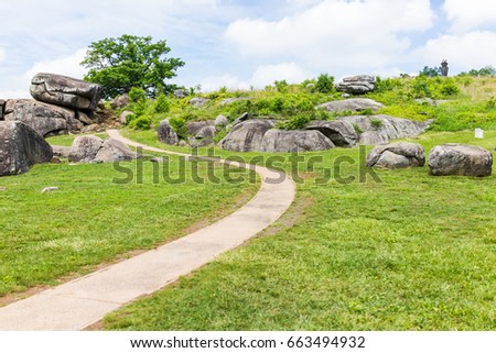 Trail leading to Devil's Den in Gettysburg battlefield national park with rock boulders during summer