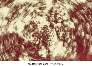 Trail of lights using zoom techniques with camera rotation, on a forest background.  Blur in a circular motion, old style colored. Abstract texture with radial motion,circular motion,circular rotation