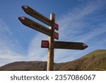 Trail markers and hiking posts indicating the direction to follow on a hiking trail.Copy space.