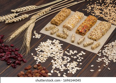 Trail Mix, Cereal Granola Bars, Sunflower Seeds, Raisins And Wheat Sprig On Wooden Background. Energy Healthy Vegetarian Snack. Top View
