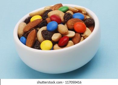 Trail Mix In A White Bowl On Blue Background