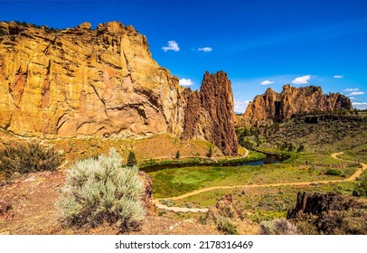 A trail in a mountain canyon among rocks. Mountain canyon landscape. Red rocks in canyon. Mountain rocks in canyon