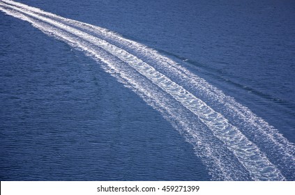 Trail on sea surface behind of speed boats