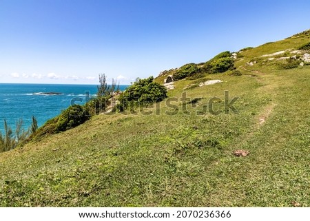 Trail over cliffs with roack and vegetation, Praia do Ouvidor, Garopaba, Santa Catarina, Brazil
