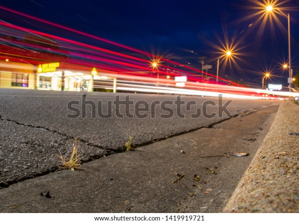 A trail of red\
taillights is illuminates the asphalt\'s surface on South Congress\
Avenue in Austin, Texas. 