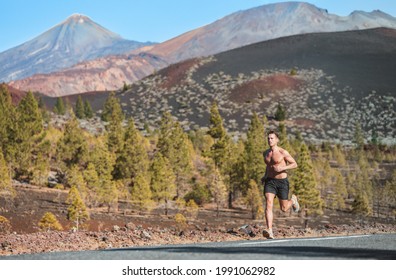 Trail Run Sport Athlete Runner Man Shirtless Sweating In Summer Sun Long Distance Endurance Running In Volcano Mountain Forest Nature Landscape. Summer Outdoor Training Healthy Active Lifestyle.